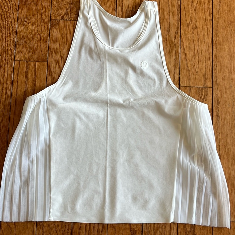 Size 4 white lululemon ruffle tank.  Excellent condition!